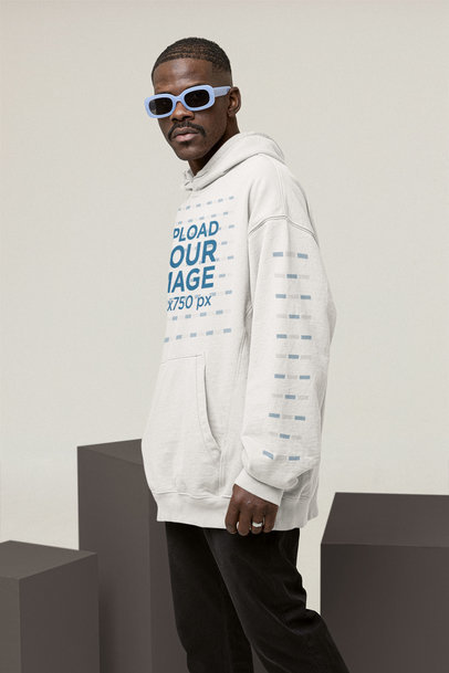 Mockup of a Cool Man Wearing a Hoodie with a Customizable Sleeve