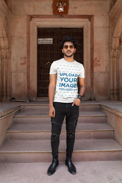 Round-Neck Tee Mockup of a Bearded Man with Sunglasses Posing by an Ancient Temple