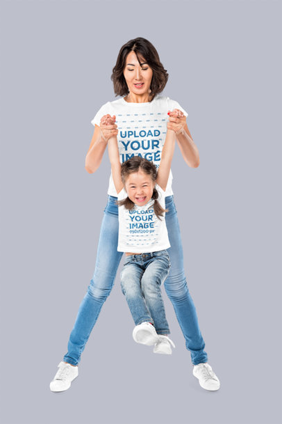T-Shirt Mockup Featuring a Woman Playing With Her Daughter in a Studio