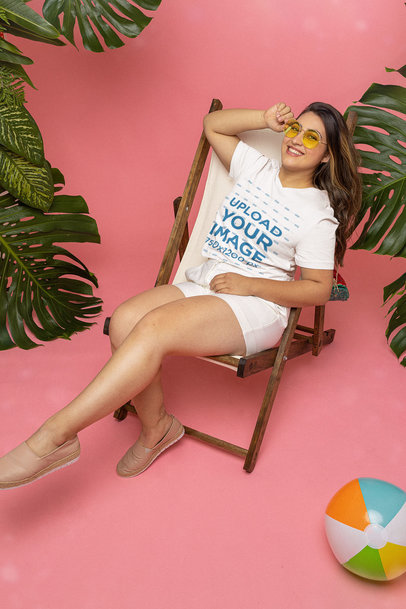 T-Shirt Mockup Featuring a Woman Relaxing on a Beach Chair