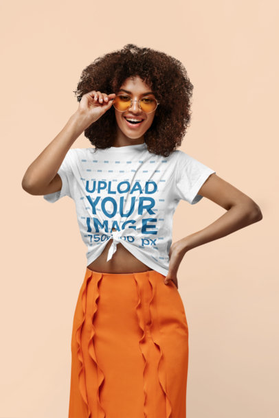 Mockup of a Stylish Woman Posing With a Knotted T-Shirt at a Studio
