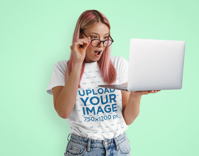 T-Shirt Mockup Featuring a Surprised Woman Looking at a Laptop m24195-r-el2