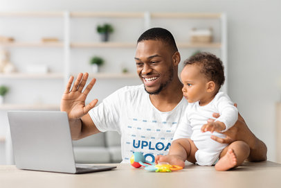 T-Shirt Mockup of a Proud Father and His Baby Having a Family Video Call