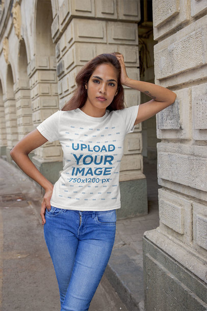 T-Shirt Mockup of a Serious Woman Leaning on a Pillar
