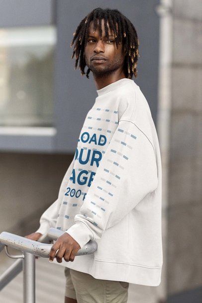 Mockup of a Man Wearing an Oversized Sweatshirt With Customizable Sleeves and Looking Sideways