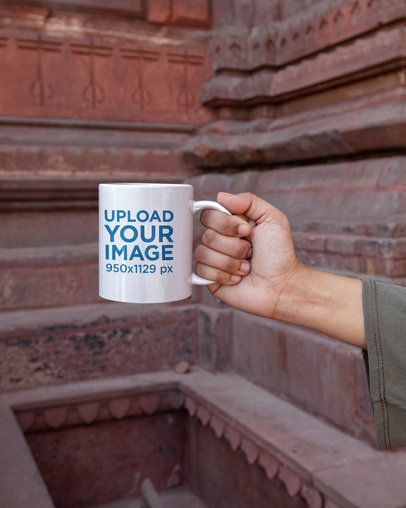 Mockup of a Woman Holding a Mug Featuring a Monument in the Background m26126