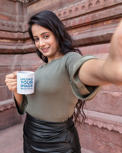Mockup of a Woman Holding a Mug While Taking a Selfie