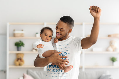T-Shirt Mockup of a Cheering Father Holding His Son in One Arm