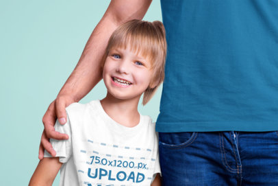 T-Shirt Mockup Featuring a Happy Kid Posing at a Studio With His Father