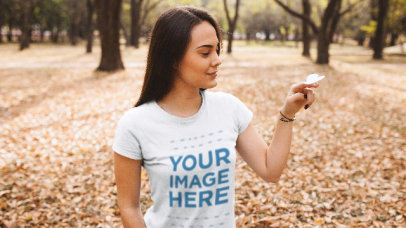 Woman at a Park Wearing a T-Shirt Stop Motion With a Paper Butterfly