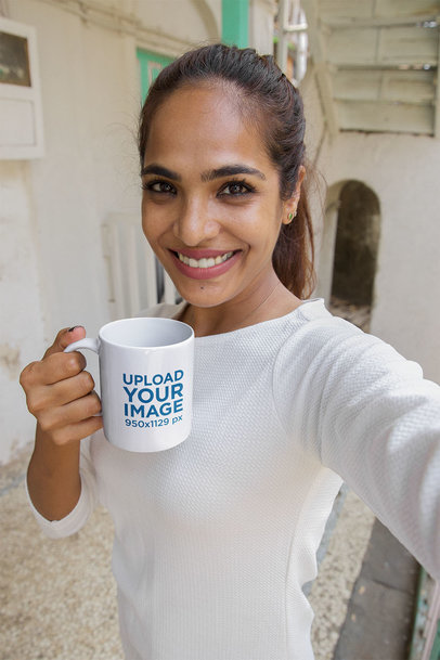 11 oz Coffee Mug Mockup Featuring a Happy Woman Taking a Morning Selfie