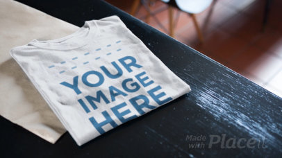 Folded T-Shirt Video Lying on a Dark Wooden Table