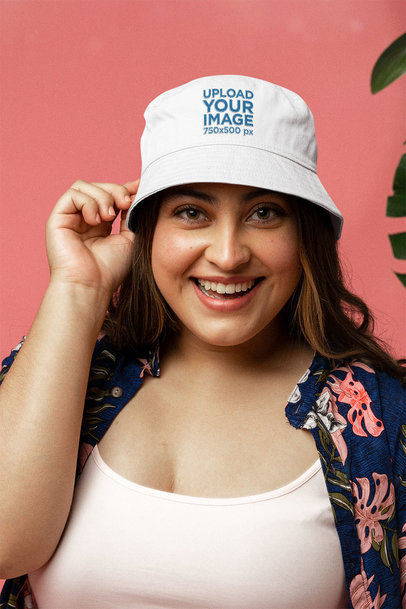 Mockup of a Happy Woman Wearing a Bucket Hat at a Studio