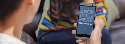 HTC One Mockup In Portrait Position Held by a Man on a Date