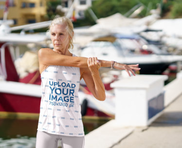 Tank Top Mockup Featuring a Senior Woman Stretching Her Arm