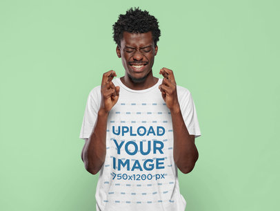 T-Shirt Mockup Featuring a Man Making the Crossed Fingers Sign