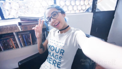 Woman Wearing a T-Shirt Video Mockup While Making Faces Indoors