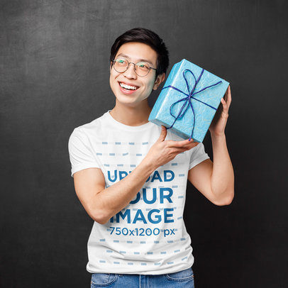 T-Shirt Mockup Featuring a Man Holding a Present