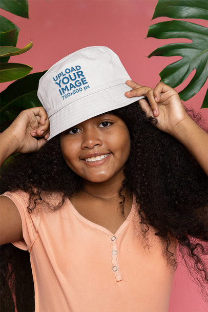 Mockup of a Happy Curly-Haired Girl Wearing a Bucket Hat at a Studio m25612