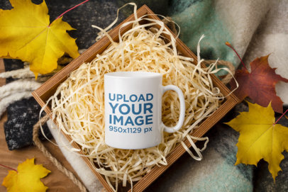 Mockup Featuring an 11 oz Coffee Mug in a Wooden Box Surrounded by Maple Leaves m25976-r-el2