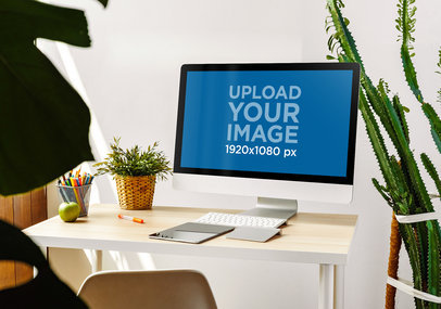 Mockup of an iMac Placed on a Desk Next to Indoor Plants