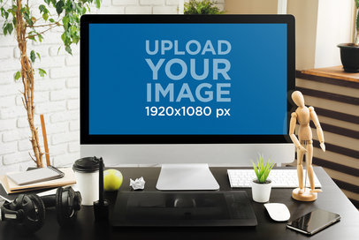 Mockup of an iMac Placed Over a Desk Featuring Office Stuff