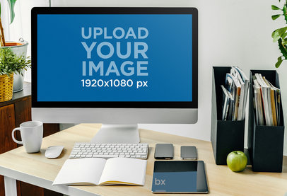Mockup of an iMac Placed on a Desk With Some Office Stuff