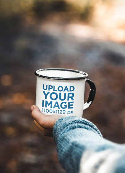 Mockup of a Man Holding an Enamel Mug Featuring a Blurry Background m26339-r-el2 