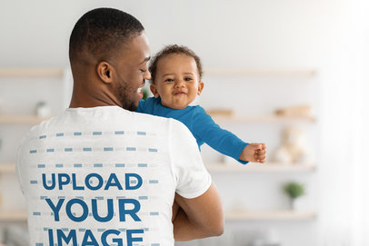 T-Shirt Mockup of the Back of a Loving Father Holding His Baby