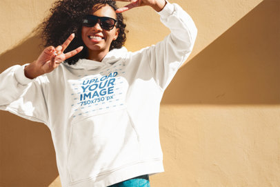 Hoodie Mockup of a Woman With Sunglasses Making Peace Signs