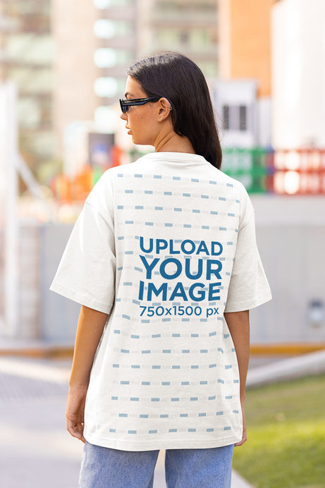 Back View Mockup of a Woman in an Oversized T-Shirt on the Street