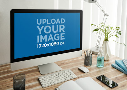 Mockup of an iMac Placed on an Organized Wooden Desk