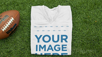 Custom Football Jerseys - Folded Jersey Near a Football at the Field