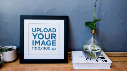 Video Mockup of a Squared Frame Leaning Over a Grey Wall