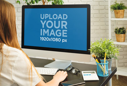 iMac Mockup Featuring a Long-Haired Woman Working
