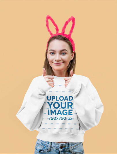 Sweatshirt Mockup of a Young Woman Posing in a Studio While Wearing Bunny Ears