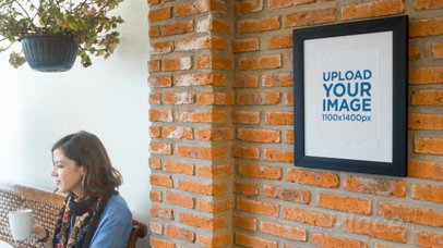 Art Print Video on a Bricks Wall While a Woman Is Texting on Her Phone Nearby