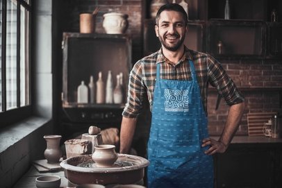Apron Mockup Featuring a Man Posing at a Pottery Workshop