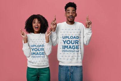 Sweatshirt Mockup Featuring a Couple with Funny Expressions Crossing Their Fingers 