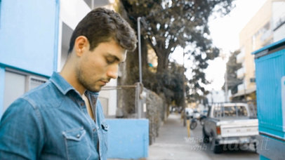Man Walking on the Street Near a Food Truck with a Flyer Video Mockup On It