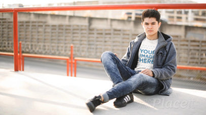 Young Man Sitting Down in an Urban Environment Wearing a TShirt Cinemagraph