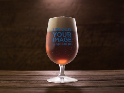  Mockup of a Snifter Beer Glass on a Dark Wooden Table