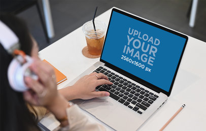 MacBook Pro Mockup Featuring a Woman with Headphones