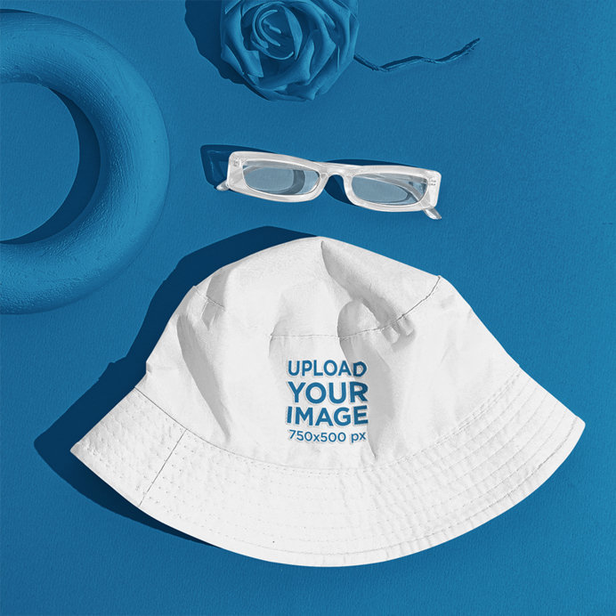 Mockup of a Bucket Hat Next to Sunglasses