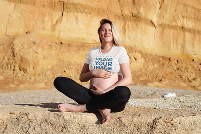 Crop Top Mockup Featuring a Pregnant Woman Sitting on a Rock