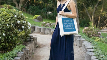 Pretty Girl Holding a Tote Bag at a Garden Path Video a13879