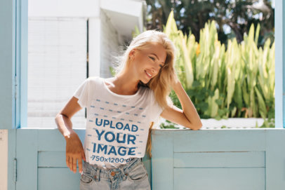 T-Shirt Mockup of a Happy Young Woman Posing in a Stable