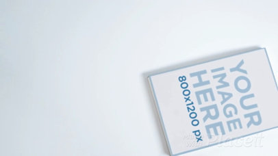 Video Hovering Over a Book Lying on a White Surface