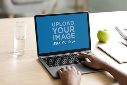 Mockup Featuring a Man Working On His MacBook Pro at Home