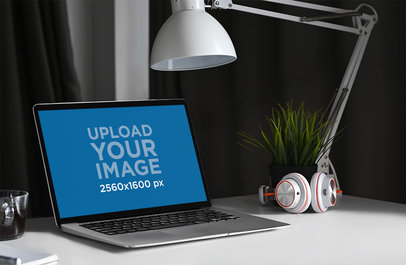 Mockup of a MacBook on a Neat Desk with Modern Headphones